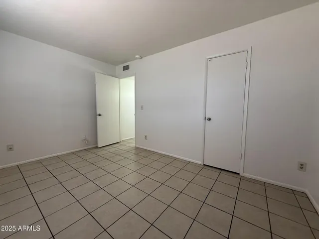 a view of an empty room and wooden floor