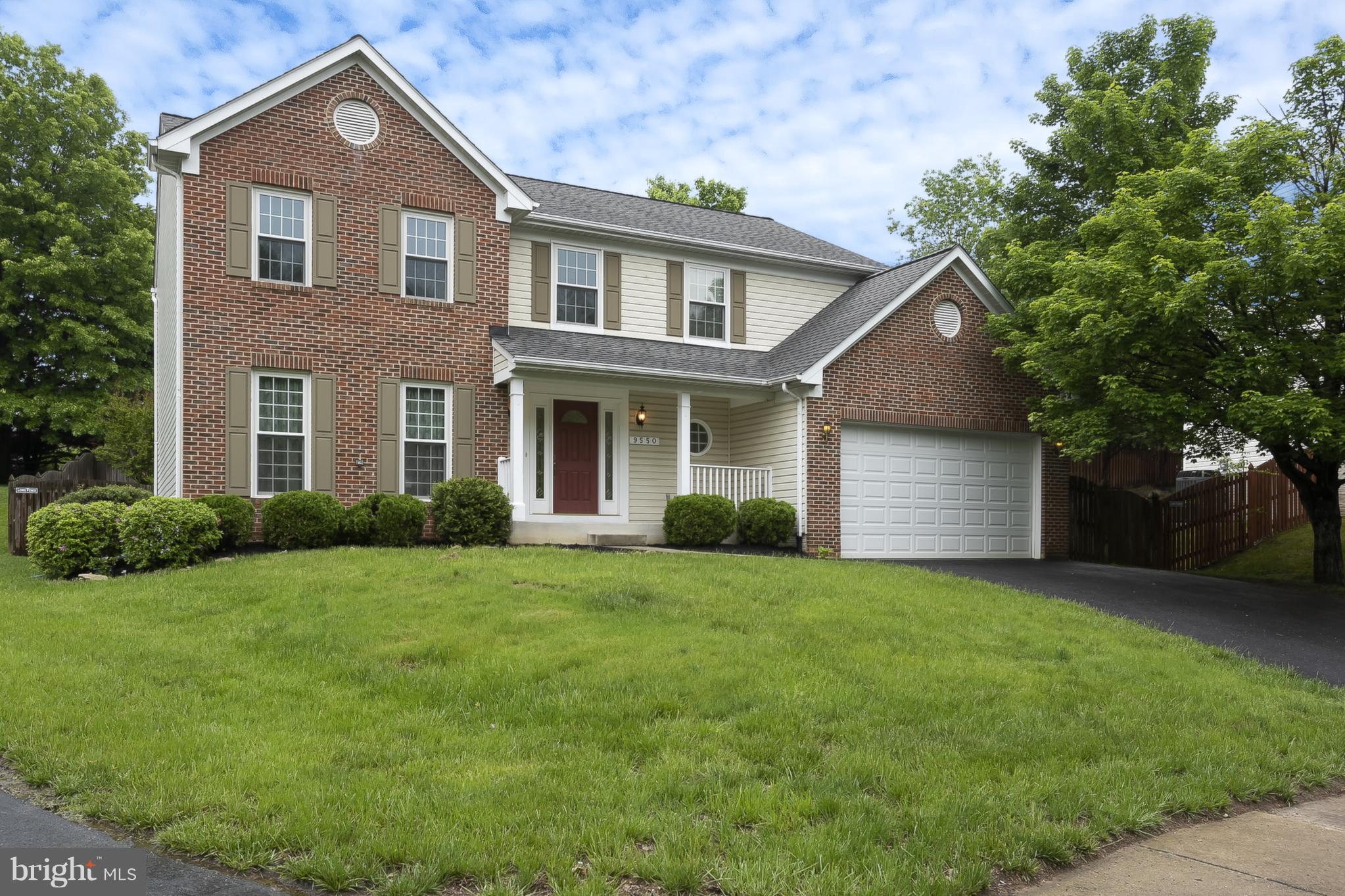9550 Ridgeview Drive Columbia, MD 21046 - Photo 1 of 30 a front view of a house with a yard and garage