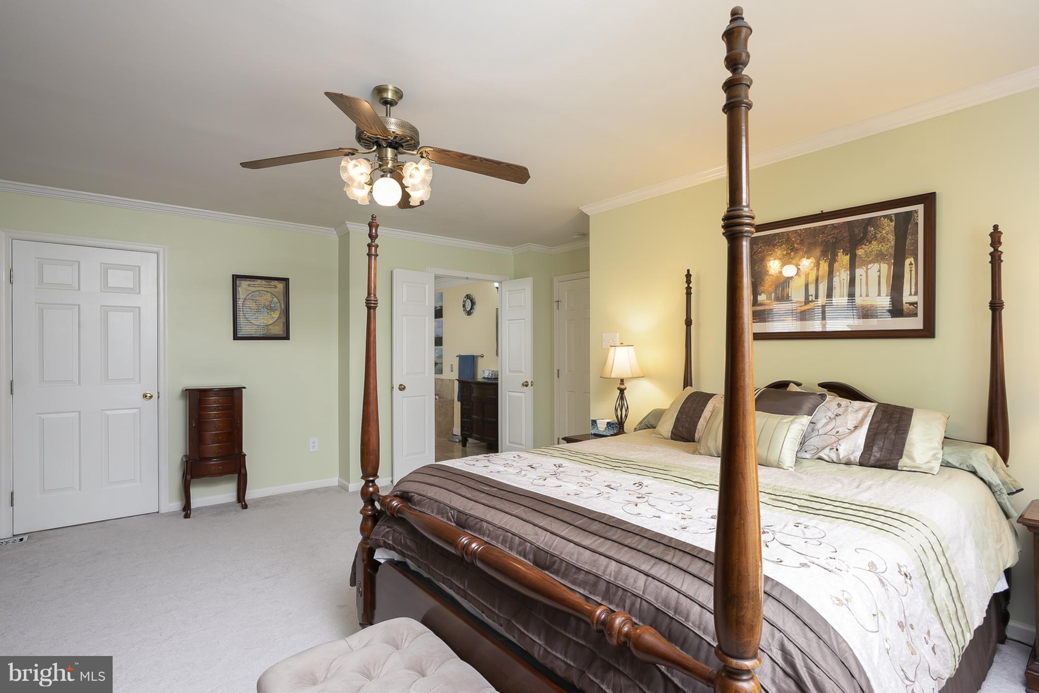 9550 Ridgeview Drive Columbia, MD 21046 - Photo 12 of 30 a bedroom with a bed and a chandelier