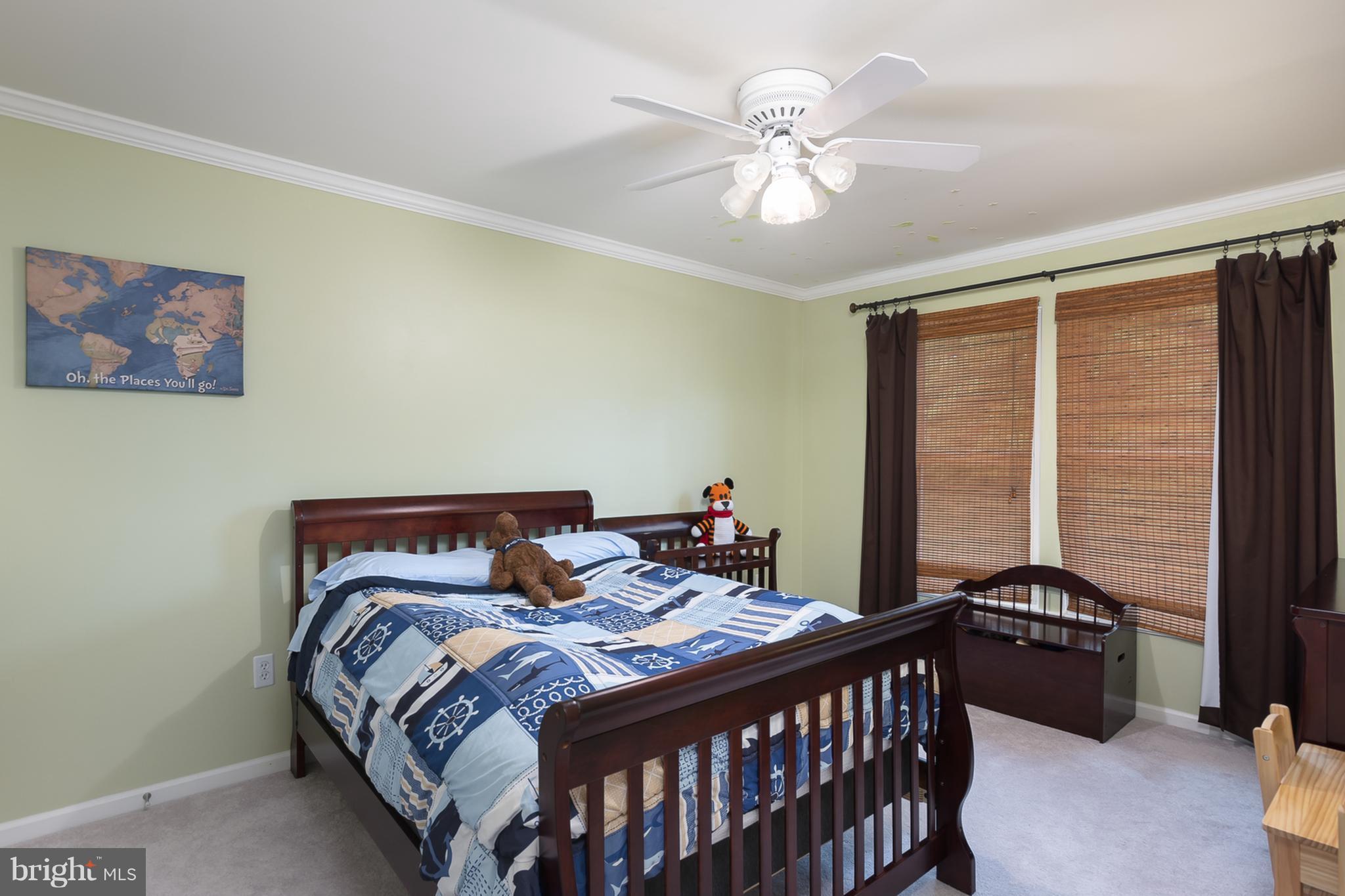 9550 Ridgeview Drive Columbia, MD 21046 - Photo 19 of 30 a bedroom with a bed and a chandelier