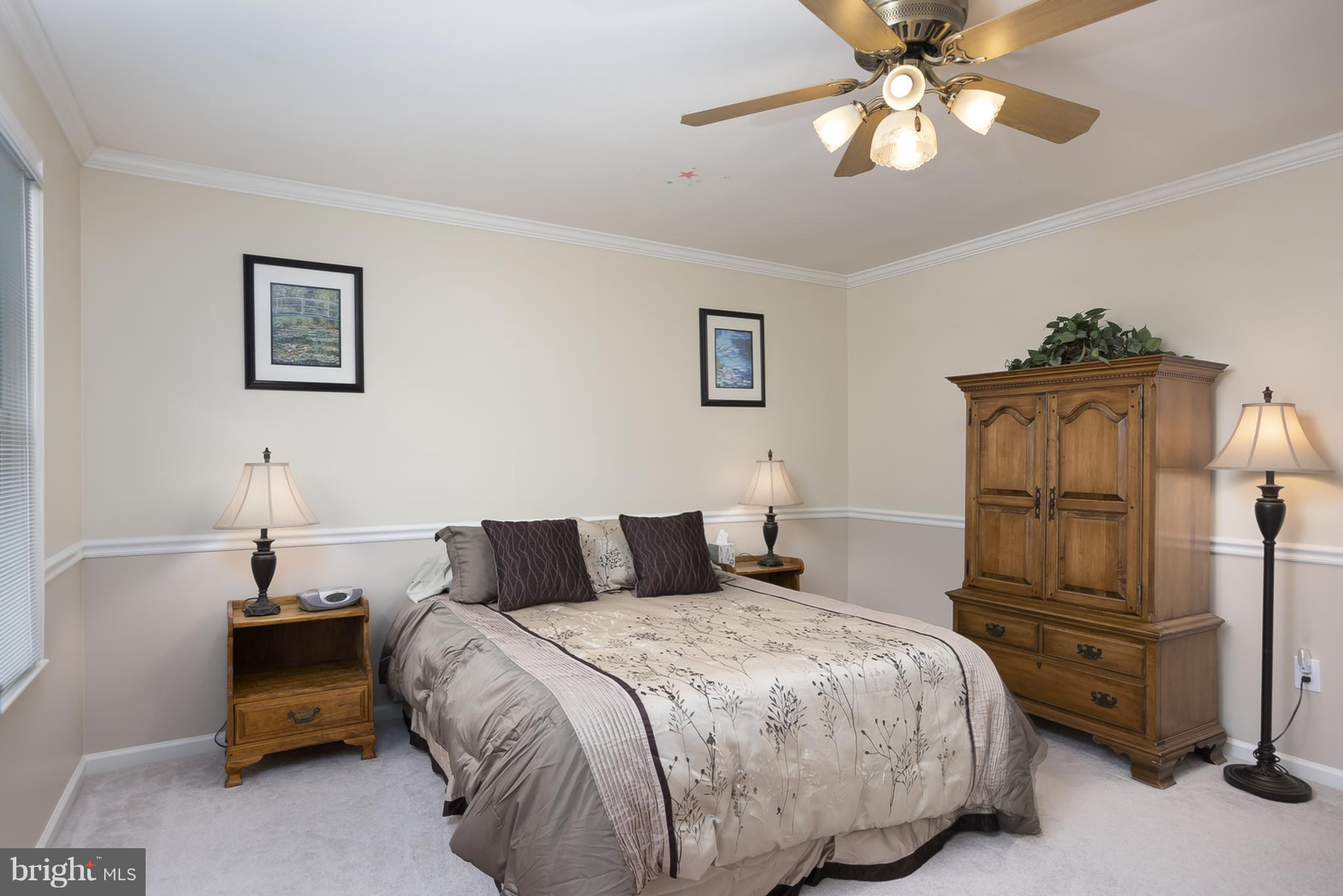 9550 Ridgeview Drive Columbia, MD 21046 - Photo 21 of 30 a bedroom with a bed and a chandelier