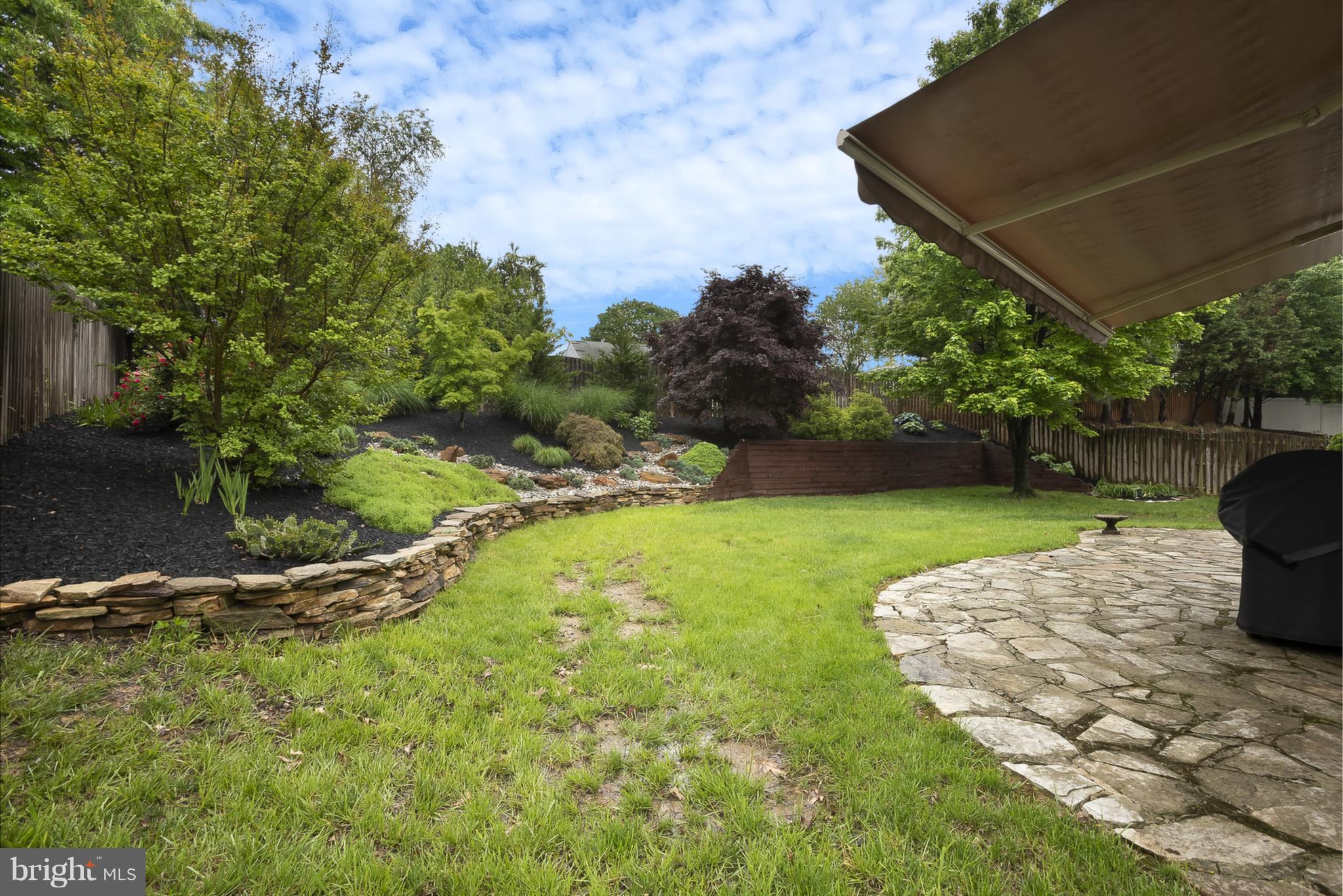 9550 Ridgeview Drive Columbia, MD 21046 - Photo 26 of 30 a view of a backyard with plants and a patio
