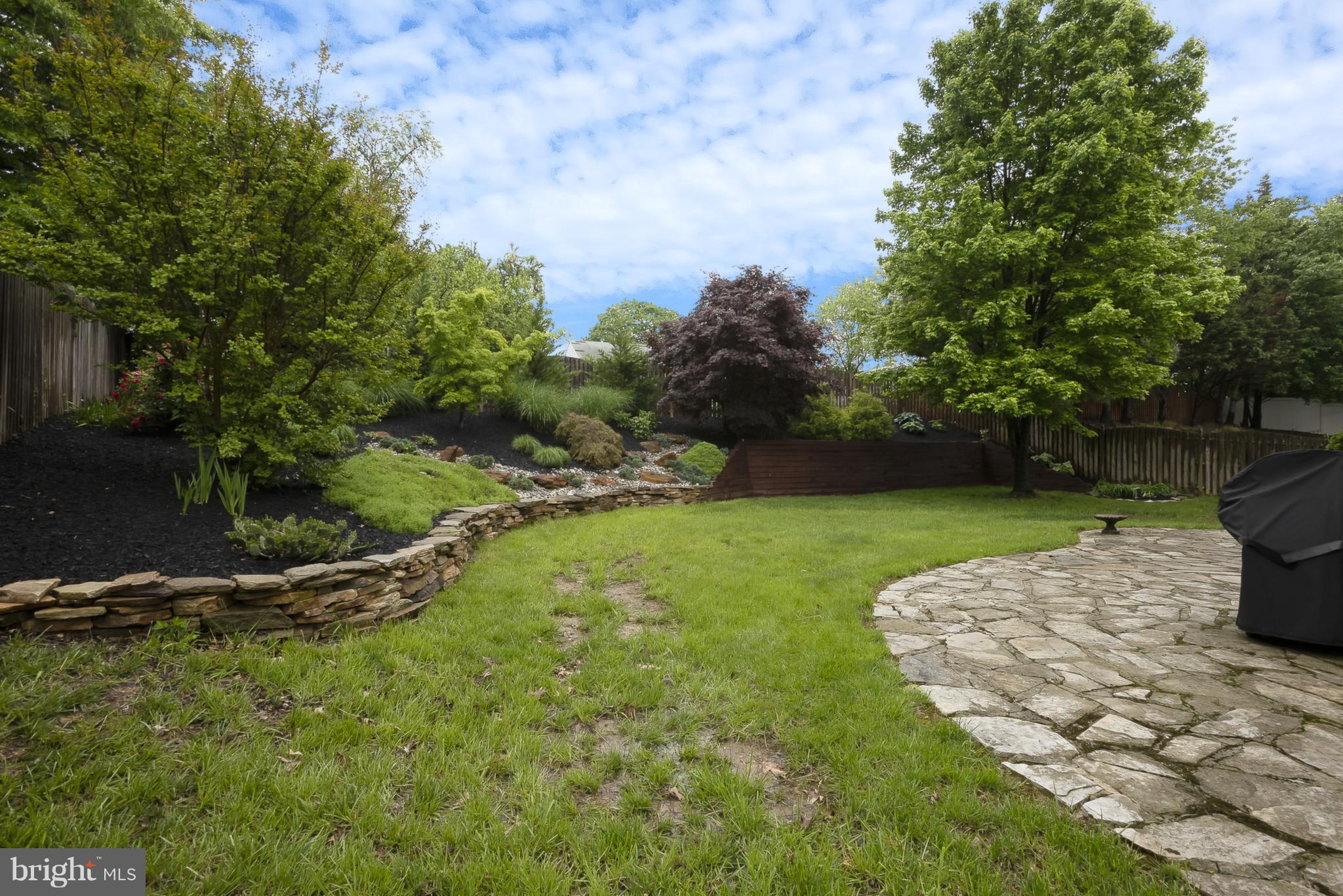 9550 Ridgeview Drive Columbia, MD 21046 - Photo 27 of 30 a view of a backyard with plants and a bench