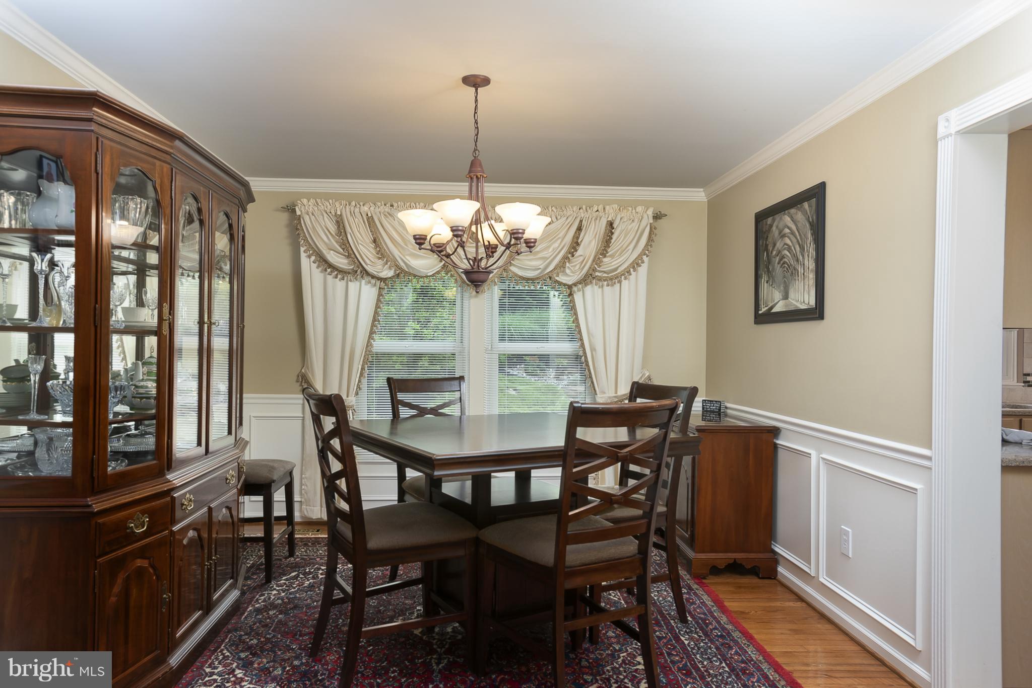 9550 Ridgeview Drive Columbia, MD 21046 - Photo 5 of 30 a view of a dining room with furniture a chandelier and wooden floor