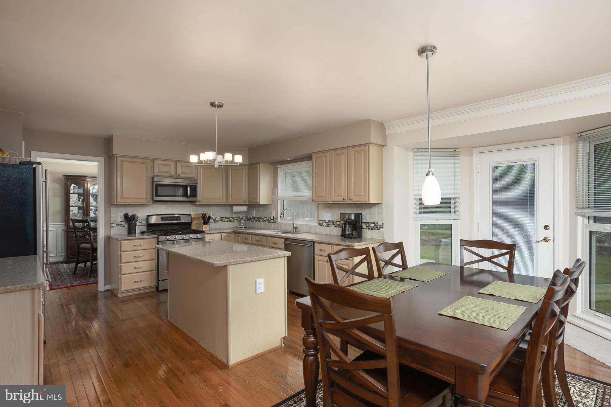 9550 Ridgeview Drive Columbia, MD 21046 - Photo 6 of 30 a view of kitchen with refrigerator stove dining table and chairs