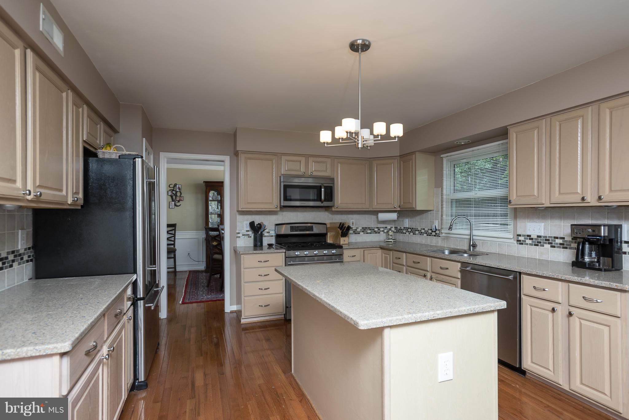 9550 Ridgeview Drive Columbia, MD 21046 - Photo 9 of 30 a kitchen with a center island appliances and cabinets