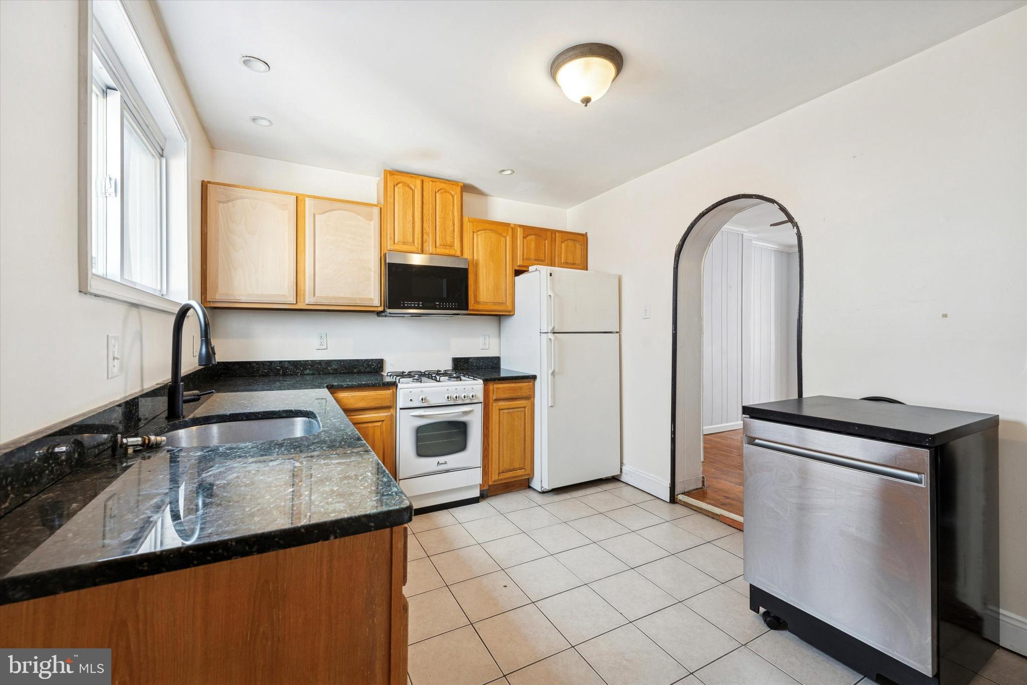 729 South Smedley Street Philadelphia, PA 19146 - Photo 12 of 25 a kitchen with a sink a stove and a refrigerator