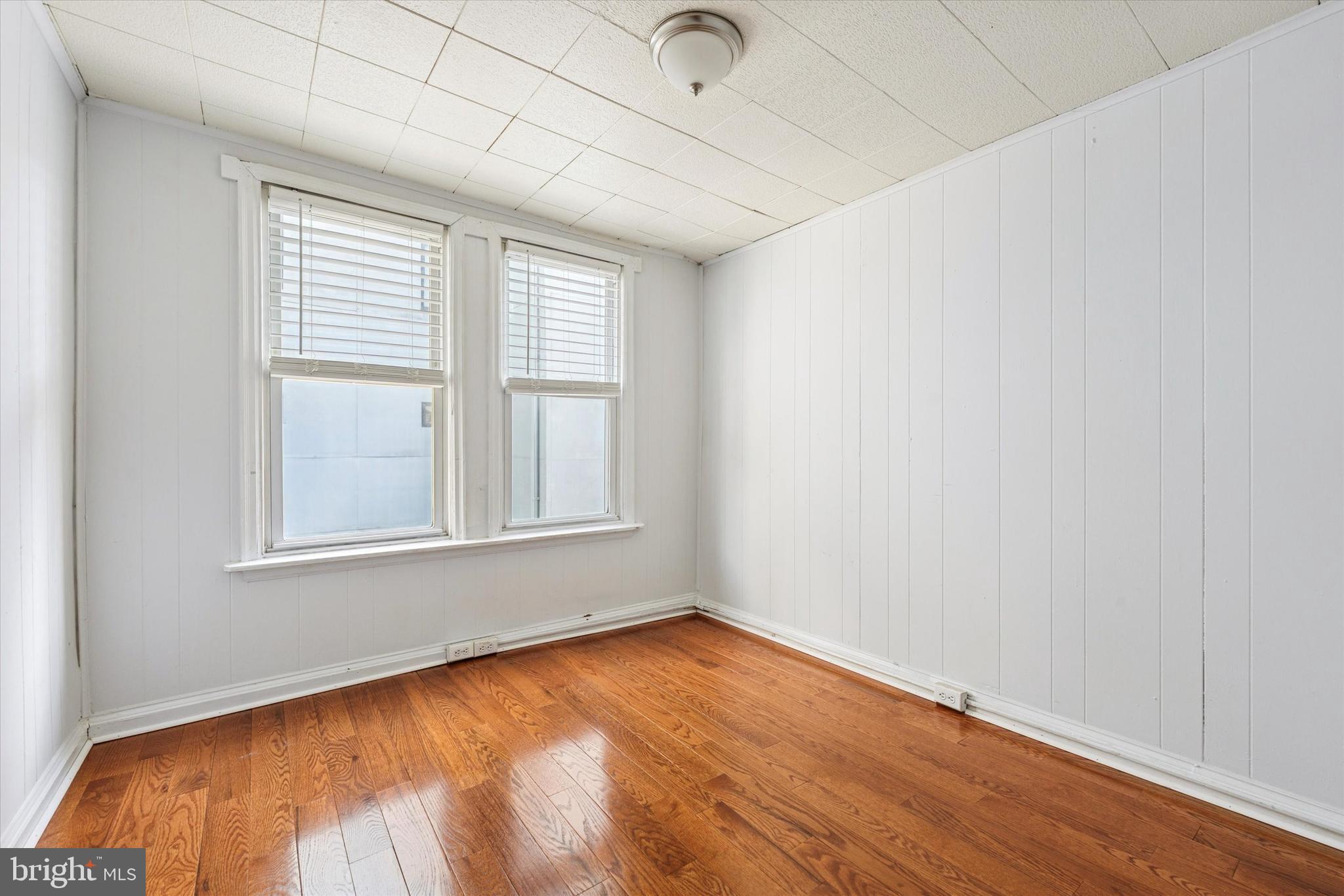 729 South Smedley Street Philadelphia, PA 19146 - Photo 13 of 25 an empty room with wooden floor and windows