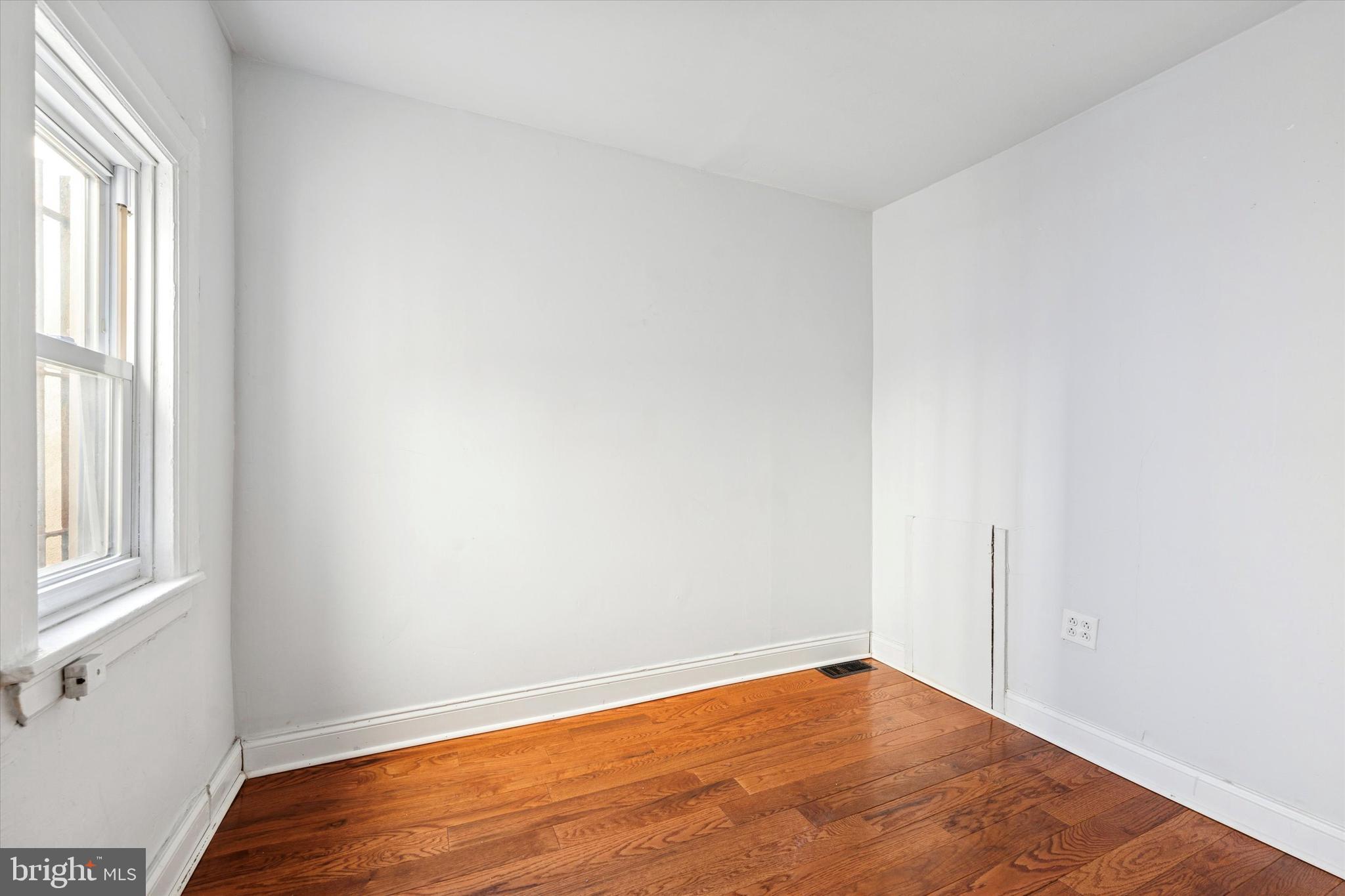 729 South Smedley Street Philadelphia, PA 19146 - Photo 15 of 25 an empty room with wooden floor and windows