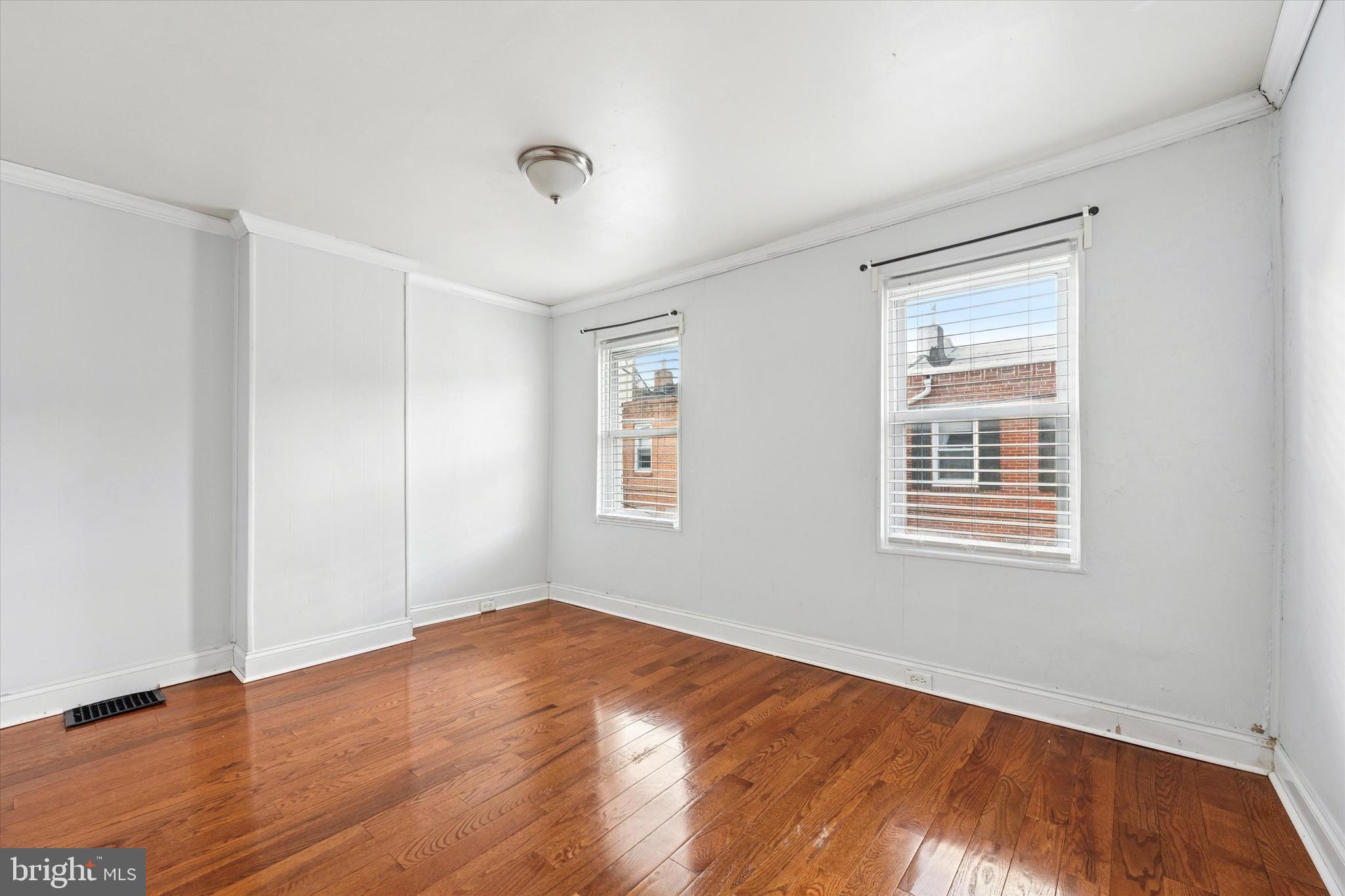 729 South Smedley Street Philadelphia, PA 19146 - Photo 17 of 25 a view of an empty room with wooden floor and a window