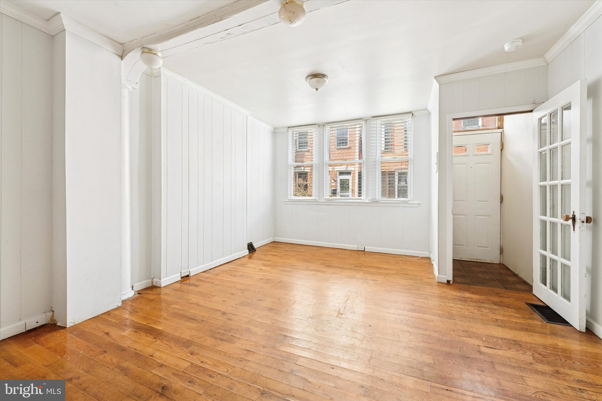 729 South Smedley Street Philadelphia, PA 19146 - Photo 5 of 25 a view of an empty room with wooden floor and a window