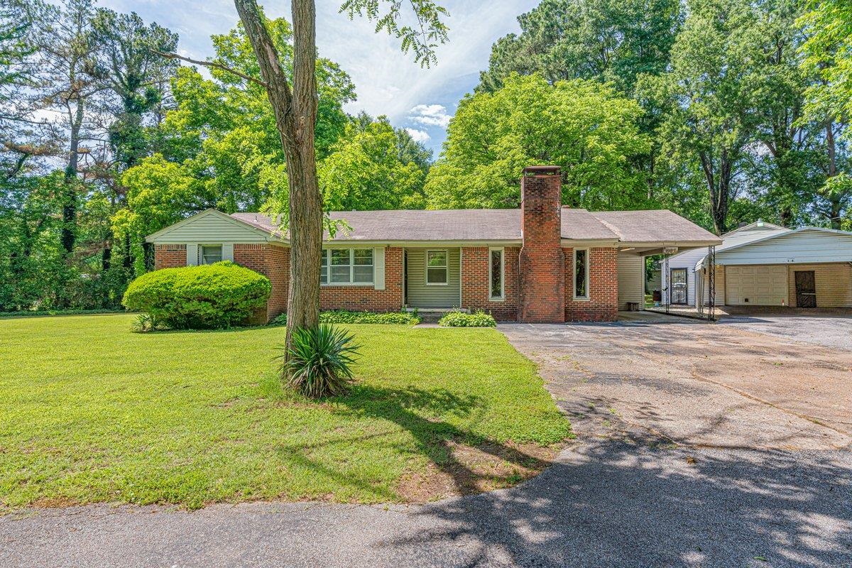 6237 Brunswick Road Arlington, TN 38002 - Photo 1 of 25 a front view of a house with a garden