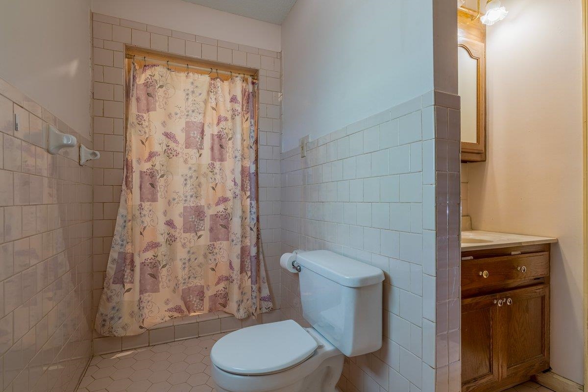 6237 Brunswick Road Arlington, TN 38002 - Photo 12 of 25 a white toilet sitting next to a shower curtain