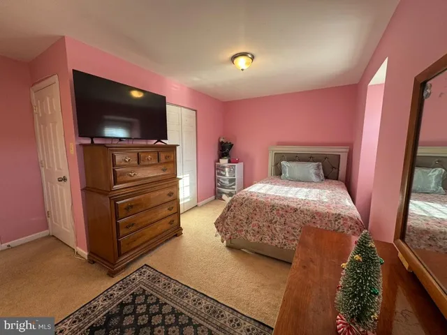 a bedroom with a bed and flat screen tv