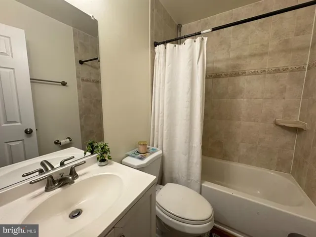 a bathroom with a sink mirror toilet and bathtub