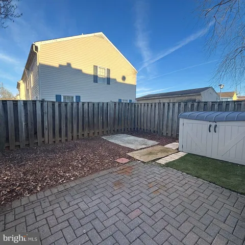 a view of a backyard with wooden fence