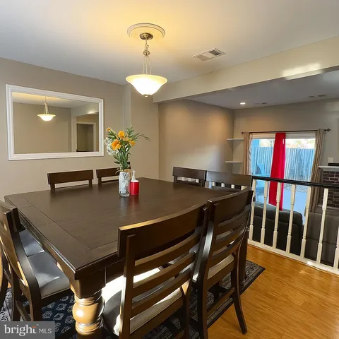 a view of a dining room with furniture and a potted plant