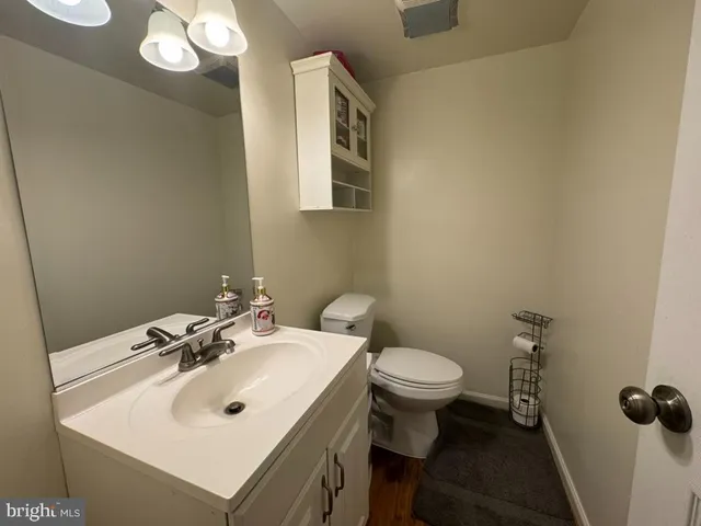 a bathroom with a sink toilet and a mirror
