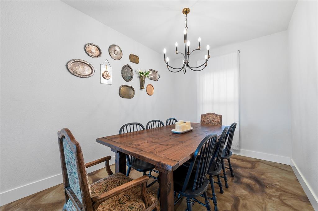 405 Advance Road Weatherford, TX 76088 - Photo 17 of 35 a view of a dining room with furniture and wooden floor
