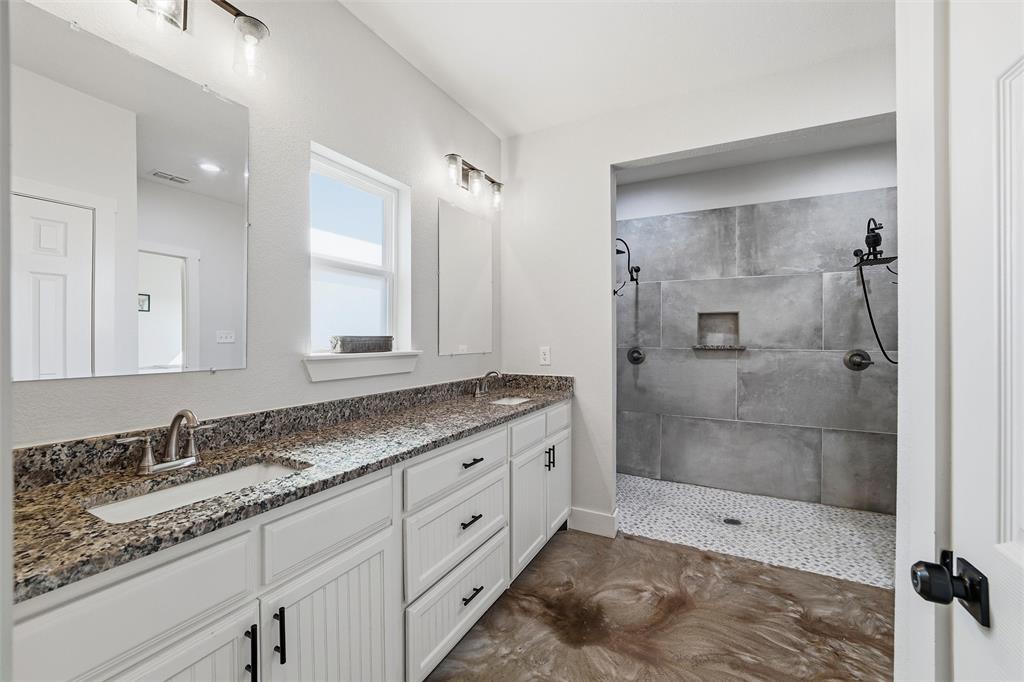 405 Advance Road Weatherford, TX 76088 - Photo 23 of 35 a bathroom with a granite countertop sink mirror and shower