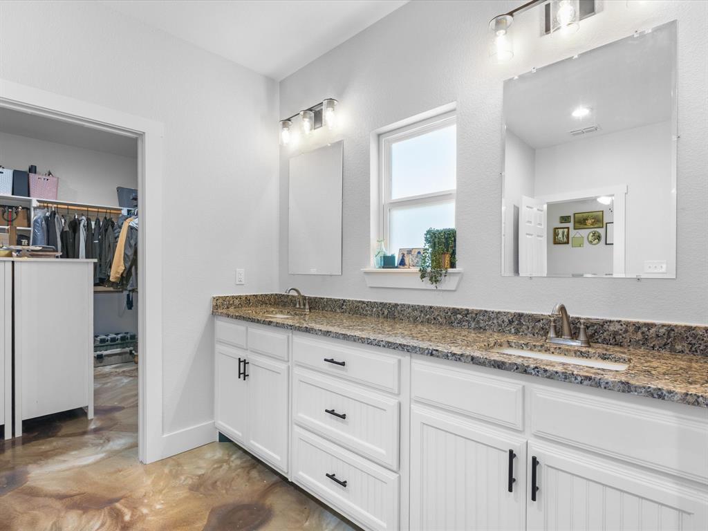 405 Advance Road Weatherford, TX 76088 - Photo 24 of 35 a bathroom with a granite countertop double vanity sink and mirror