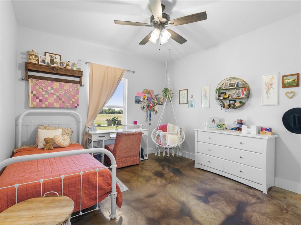 405 Advance Road Weatherford, TX 76088 - Photo 26 of 35 a bedroom with a bed and a chandelier