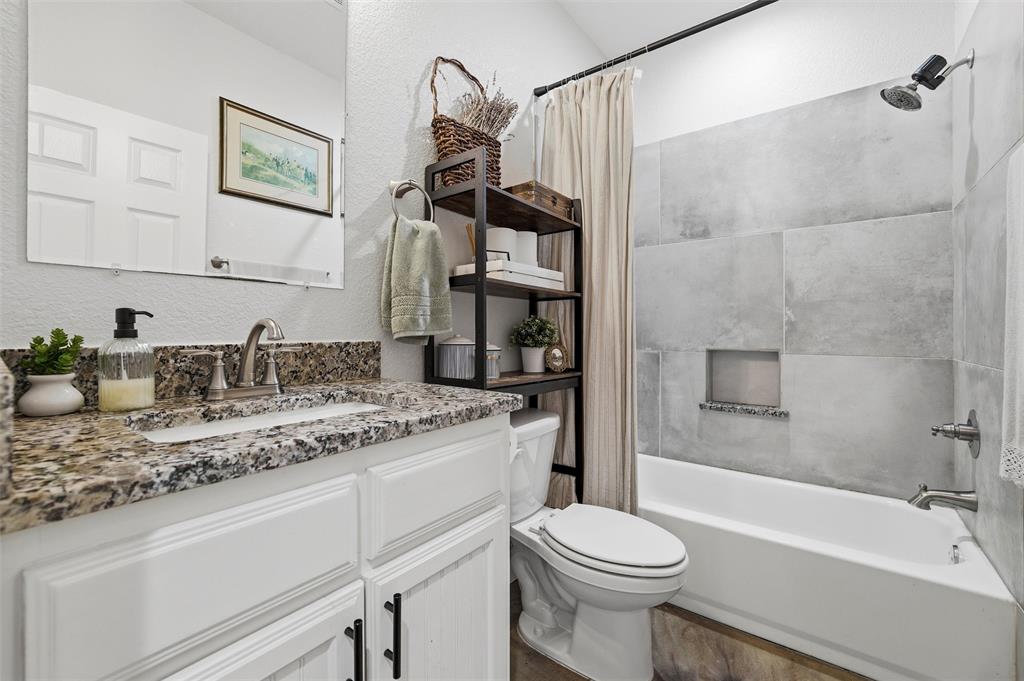 405 Advance Road Weatherford, TX 76088 - Photo 29 of 35 a bathroom with a granite countertop sink toilet and shower