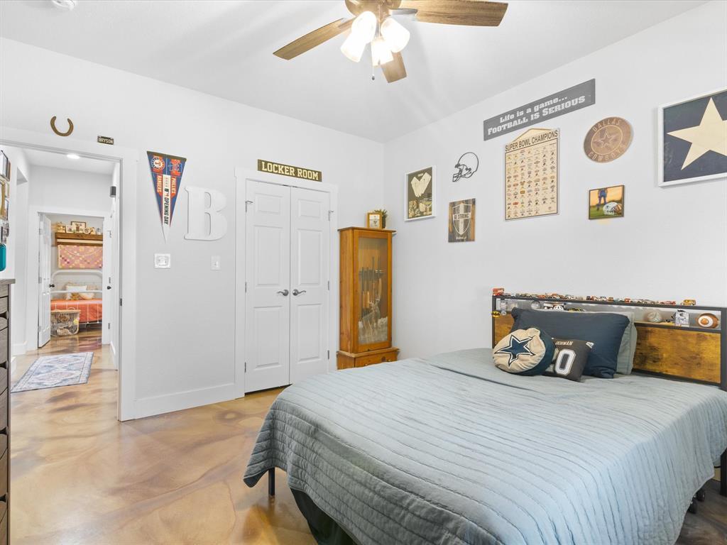 405 Advance Road Weatherford, TX 76088 - Photo 31 of 35 a bedroom with a bed and a chandelier