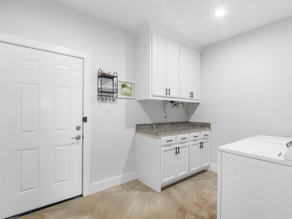 405 Advance Road Weatherford, TX 76088 - Photo 34 of 35 a kitchen with a stove and a refrigerator