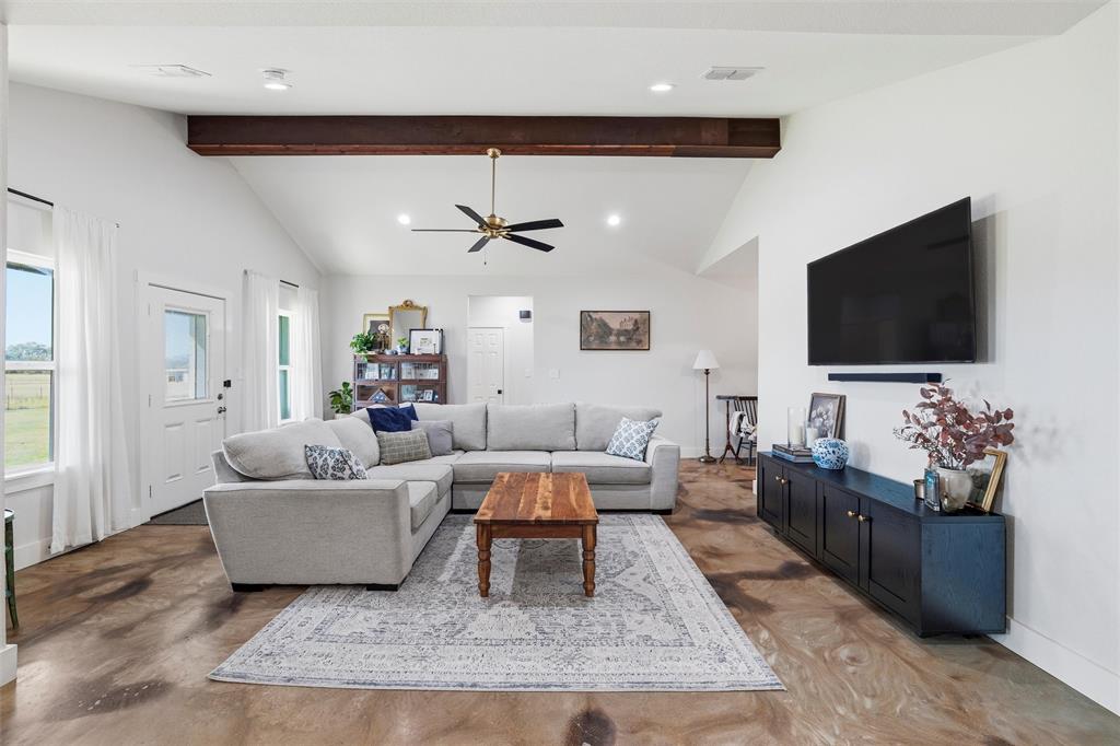 405 Advance Road Weatherford, TX 76088 - Photo 10 of 35 a living room with furniture and a flat screen tv
