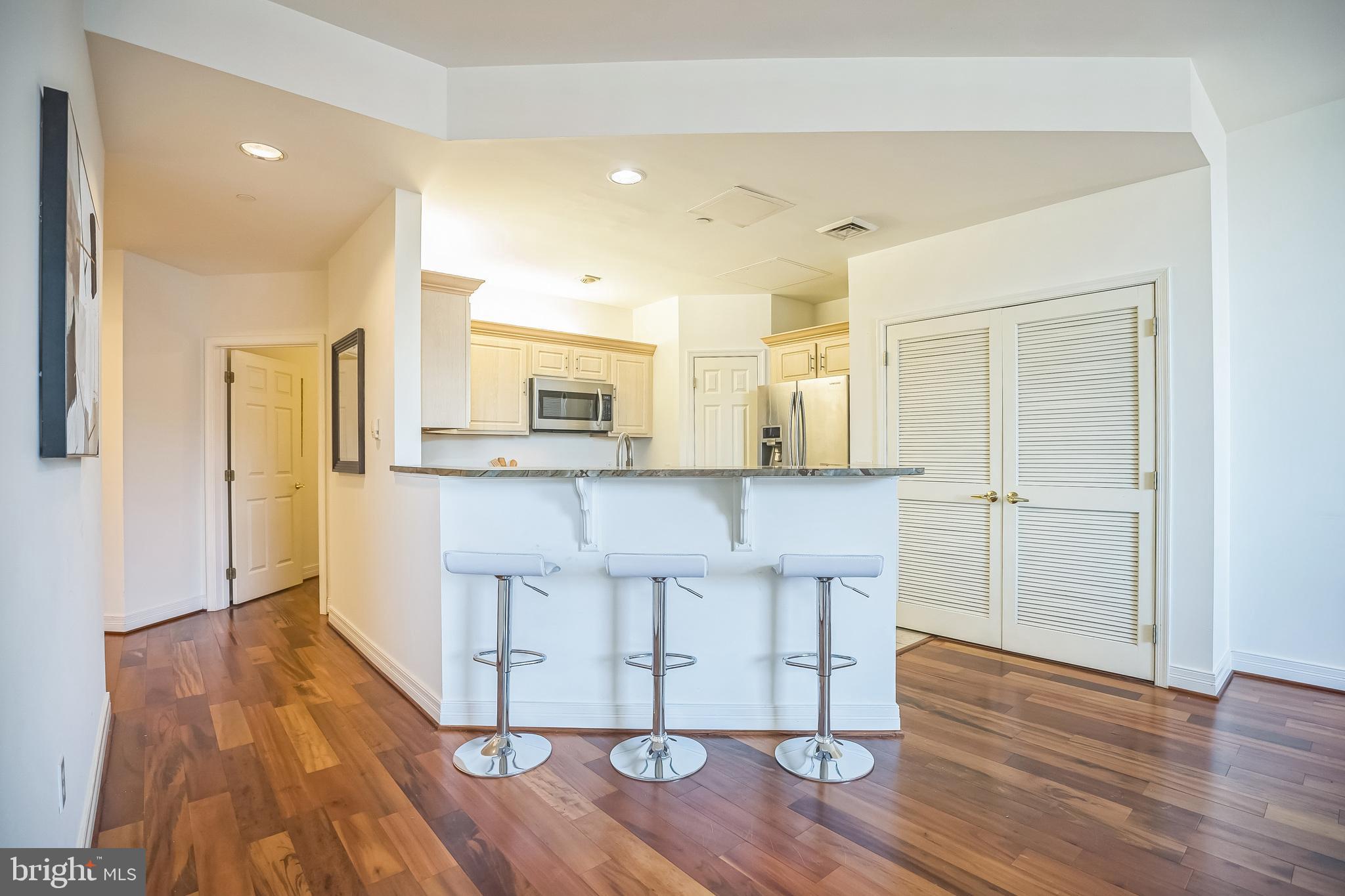 1600-18 Arch Street, Unit 1801 Philadelphia, PA 19103 - Photo 4 of 13 a large white kitchen with wooden floor