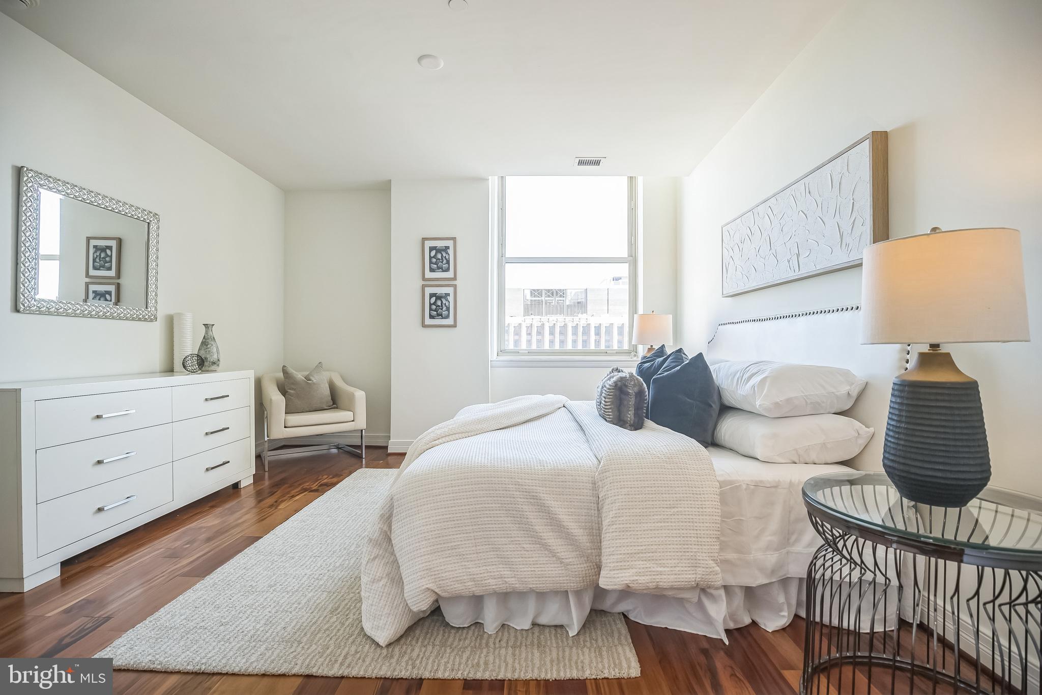 1600-18 Arch Street, Unit 1801 Philadelphia, PA 19103 - Photo 7 of 13 a bedroom with a bed and wooden floor