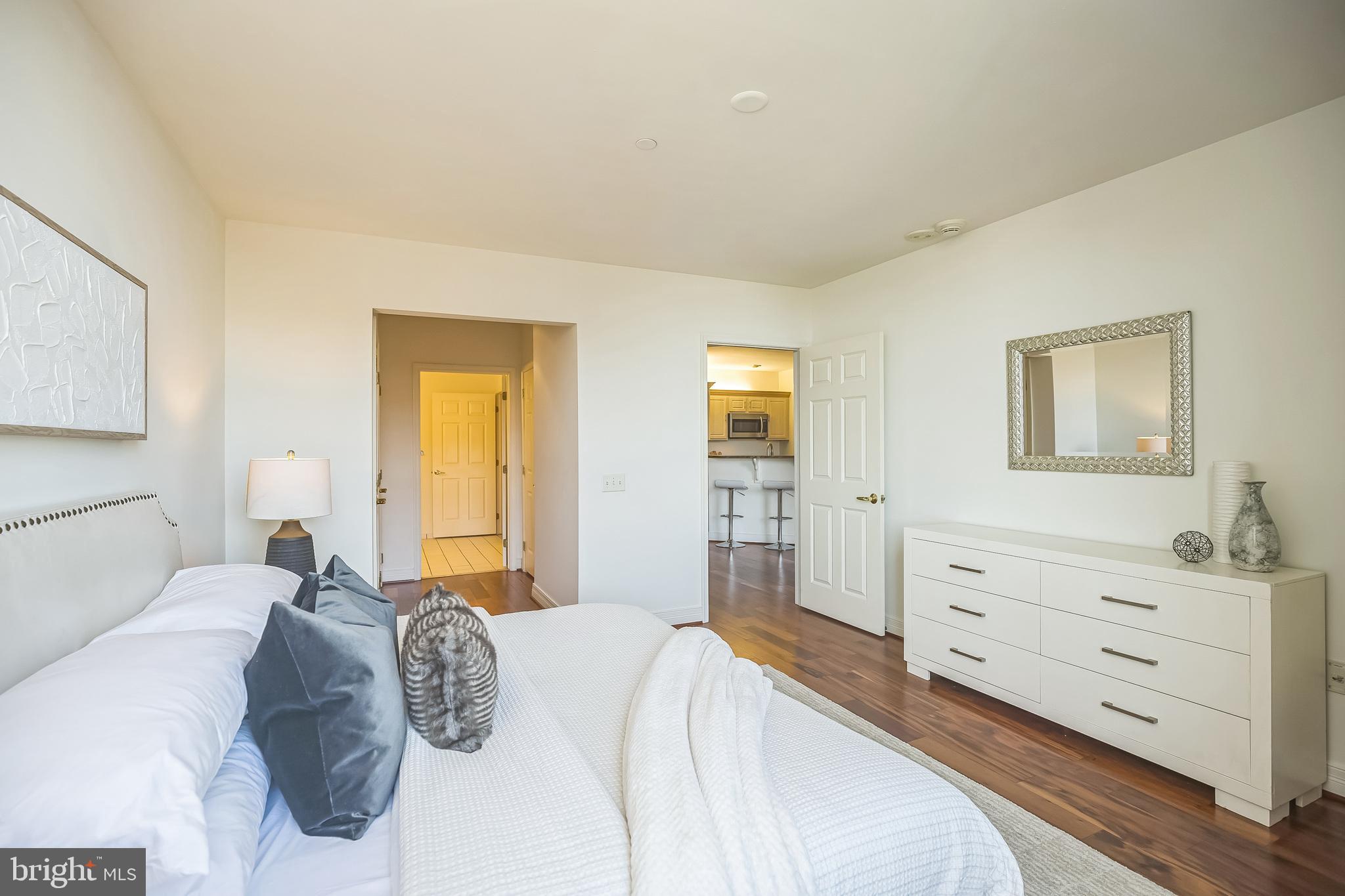 1600-18 Arch Street, Unit 1801 Philadelphia, PA 19103 - Photo 8 of 13 a bedroom with a bed and a dresser