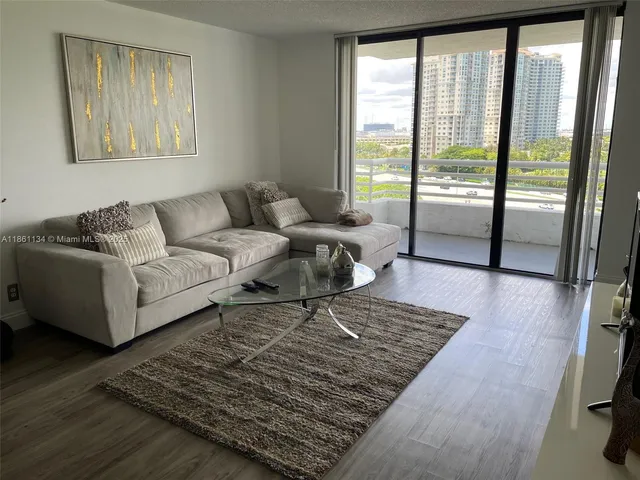 a living room with furniture and a rug