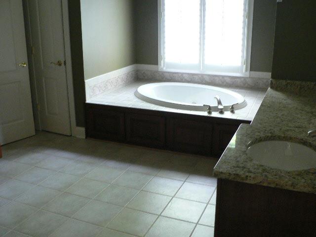 5251 Falcon Ridge Road Roanoke, VA 24018 - Photo 4 of 15 a bathroom with a granite countertop sink and a vanity