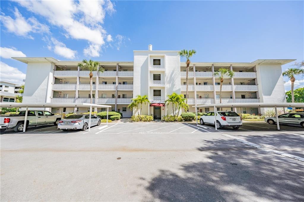 1524 Lakeview Road, Unit 401 Clearwater, FL 33756 - Photo 1 of 1 a view of a cars parked in front of a building