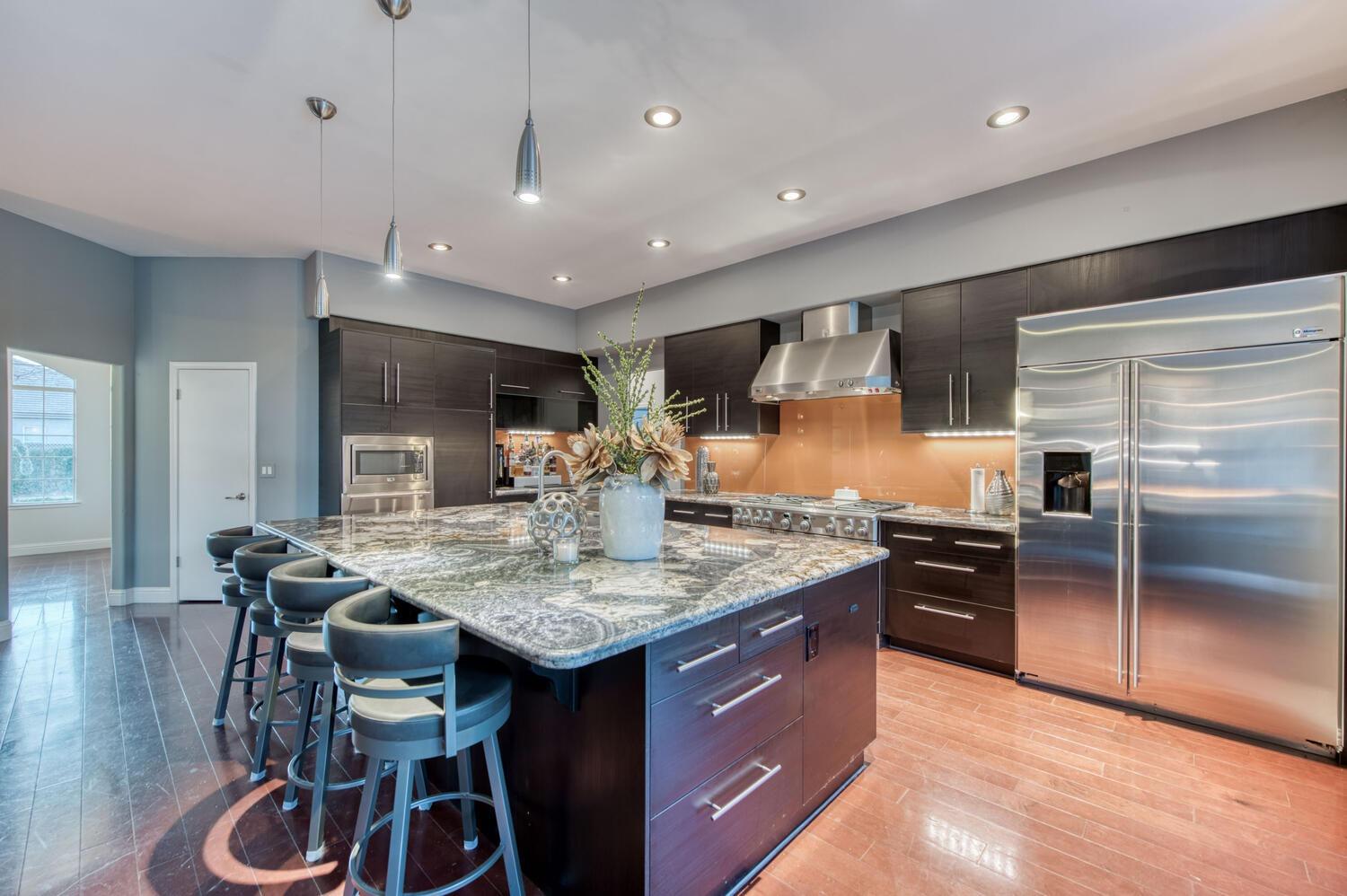 1081 North Harvard Avenue Clovis, CA 93611 - Photo 15 of 57 a kitchen with granite countertop kitchen island stainless steel appliances a sink stove and refrigerator