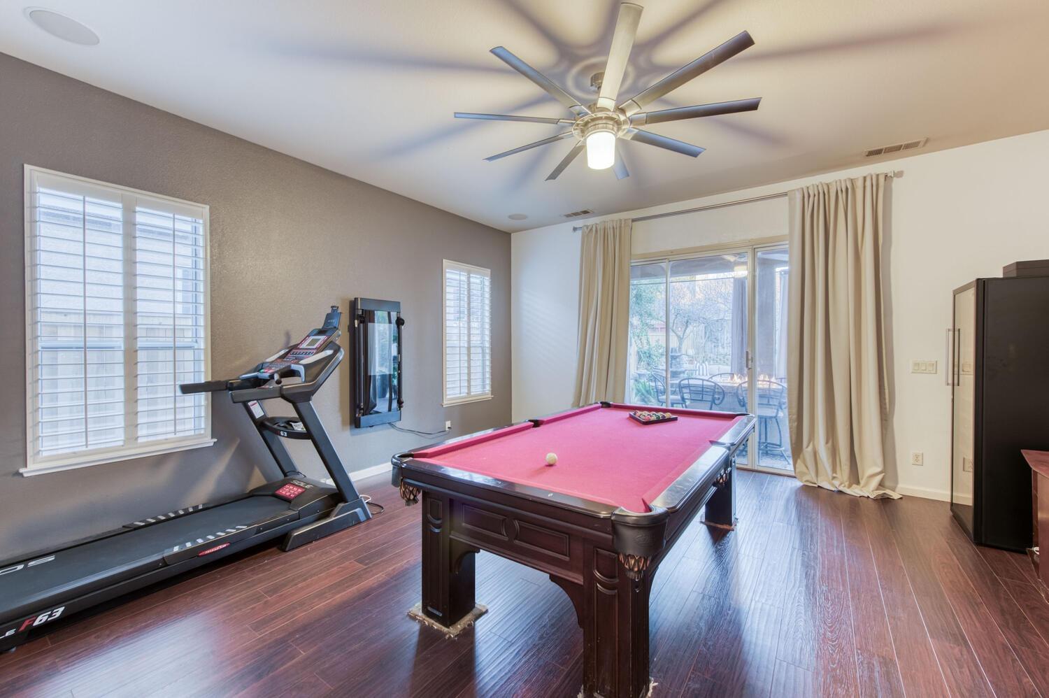 1081 North Harvard Avenue Clovis, CA 93611 - Photo 18 of 57 a room with gym equipment equipment and a window