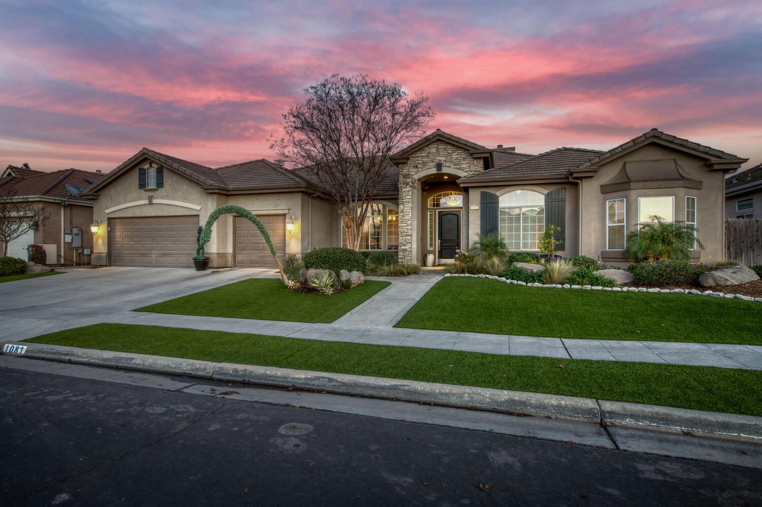 1081 North Harvard Avenue Clovis, CA 93611 - Photo 2 of 57 a front view of a house with a yard and road