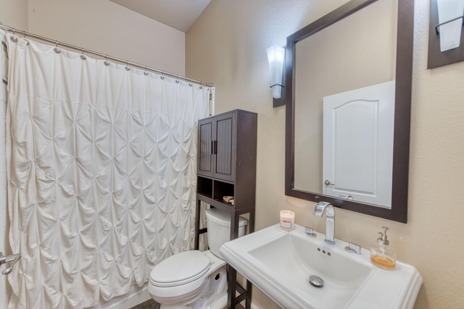 1081 North Harvard Avenue Clovis, CA 93611 - Photo 22 of 57 a bathroom with a sink toilet and mirror