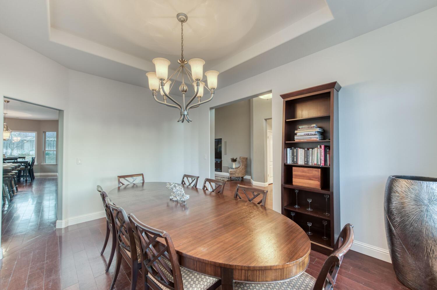 1081 North Harvard Avenue Clovis, CA 93611 - Photo 24 of 57 a view of a dining room with furniture a chandelier and wooden floor