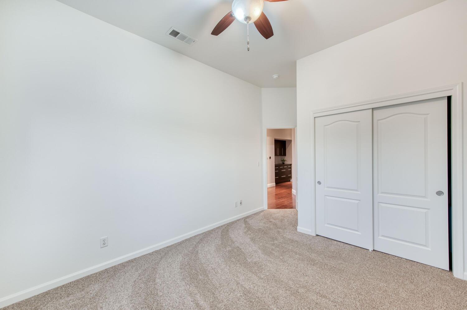 1081 North Harvard Avenue Clovis, CA 93611 - Photo 28 of 57 an empty room with closet and a ceiling fan
