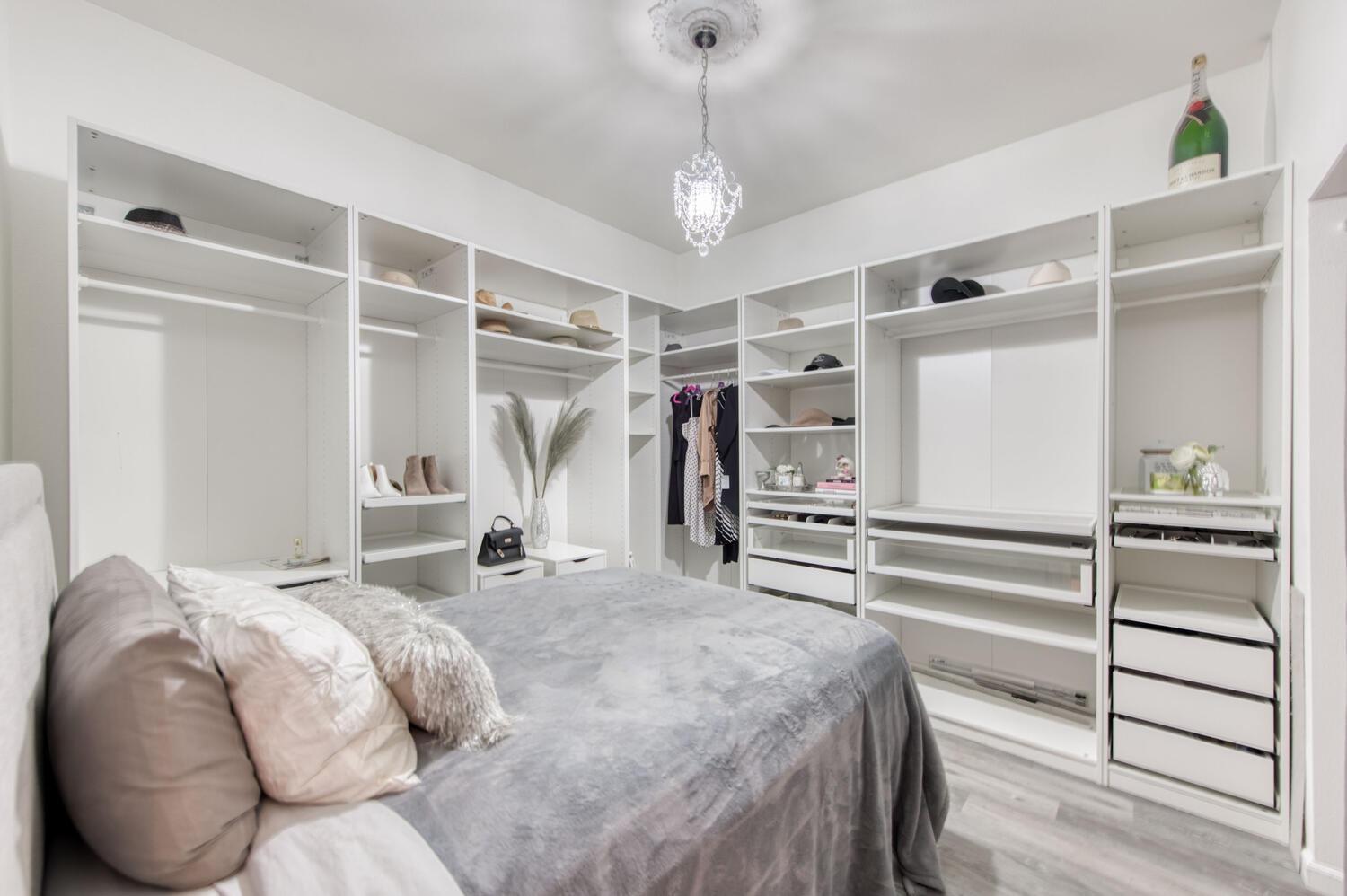 1081 North Harvard Avenue Clovis, CA 93611 - Photo 30 of 57 a bedroom with a bed and a walk in closet