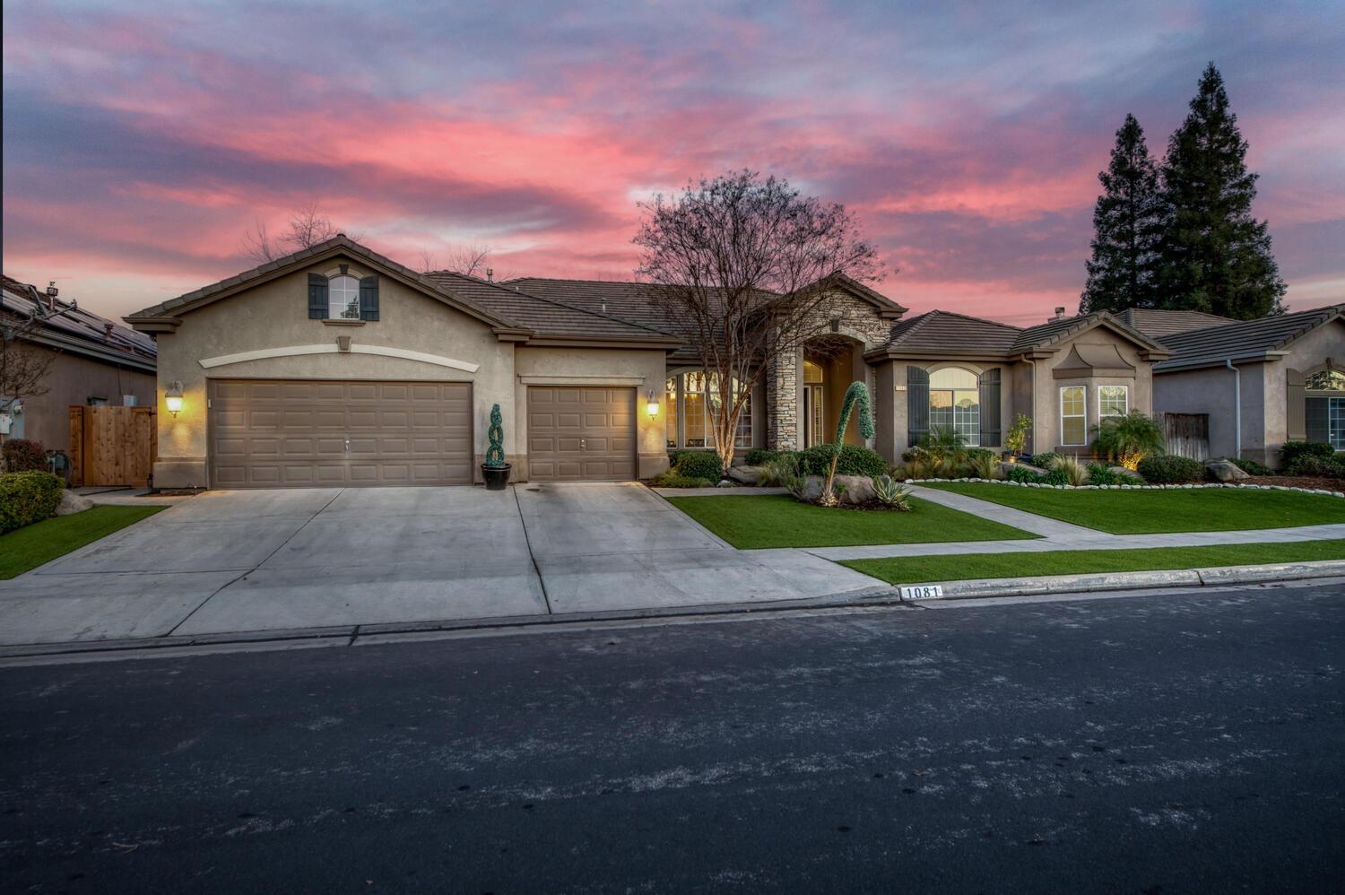 1081 North Harvard Avenue Clovis, CA 93611 - Photo 3 of 57 a front view of a house with a yard and garage