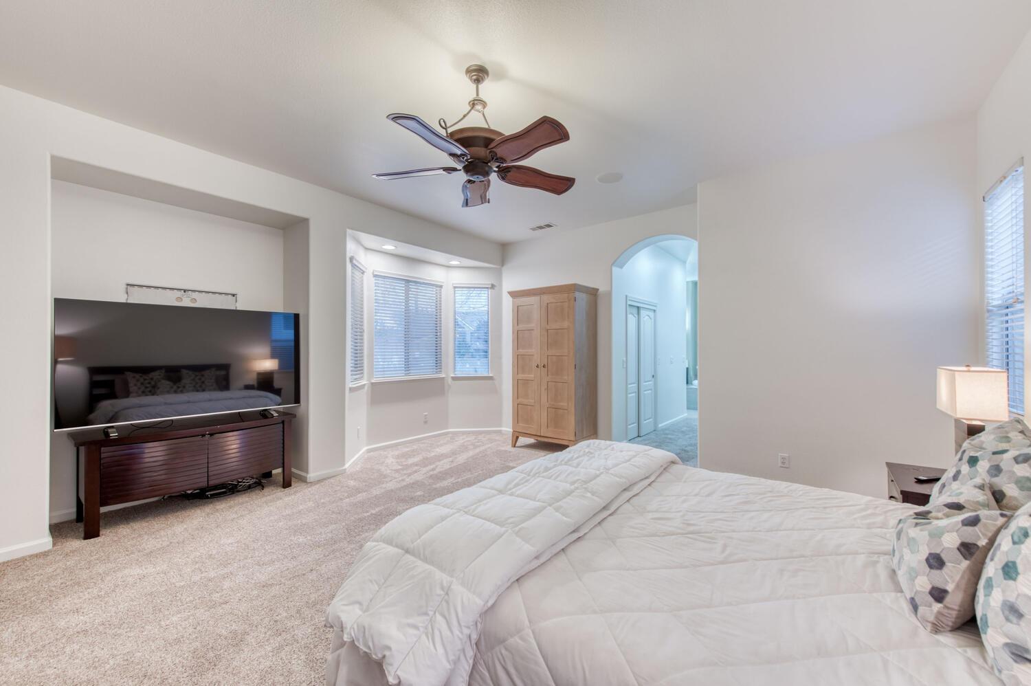 1081 North Harvard Avenue Clovis, CA 93611 - Photo 32 of 57 a bedroom with a bed and a television