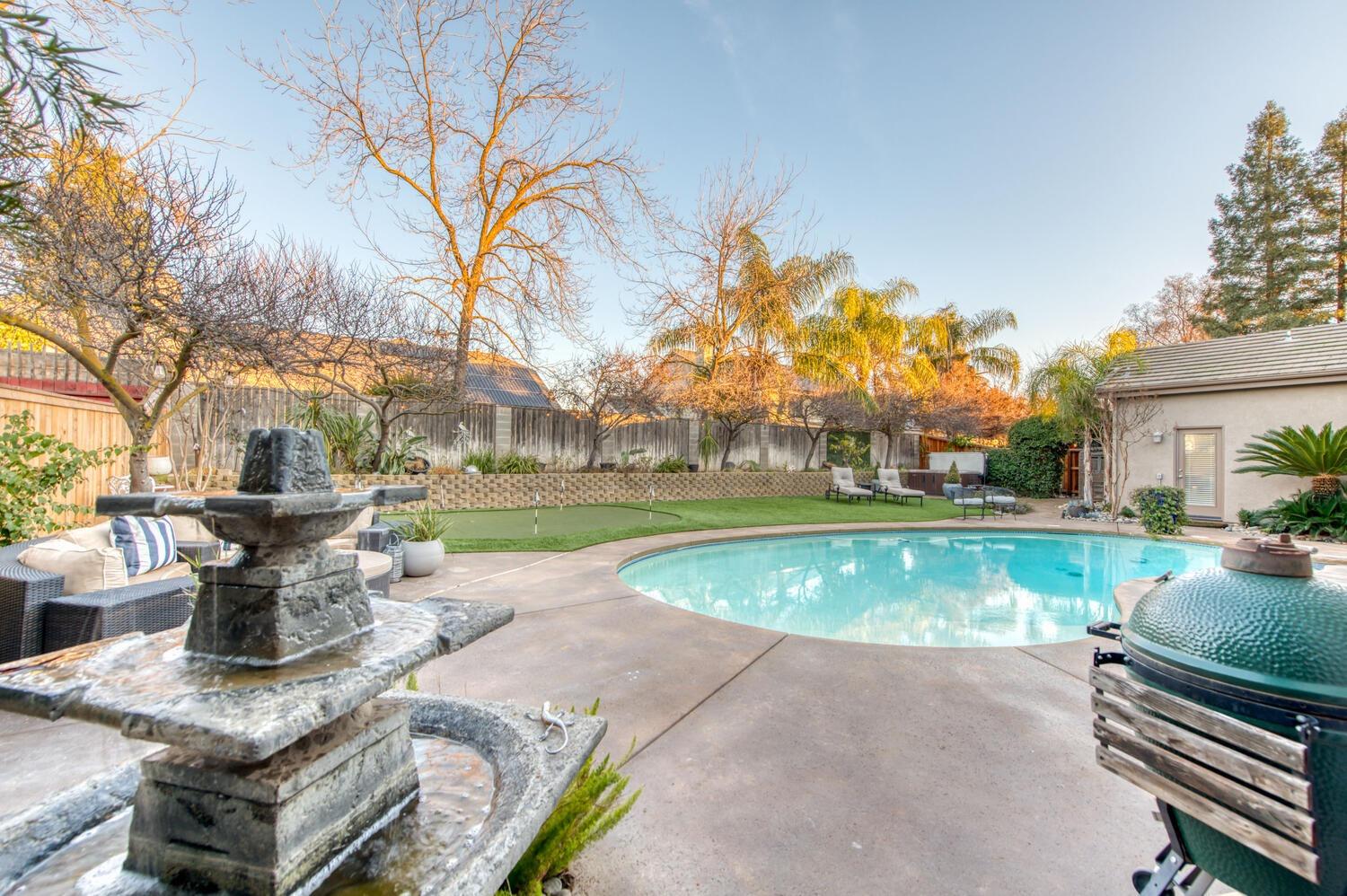 1081 North Harvard Avenue Clovis, CA 93611 - Photo 38 of 57 a view of a house with swimming pool and sitting area