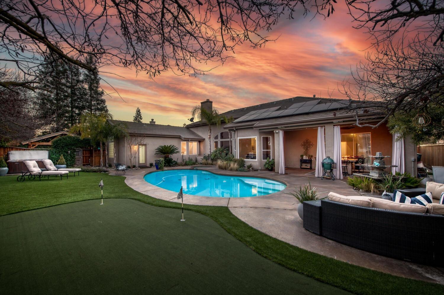 1081 North Harvard Avenue Clovis, CA 93611 - Photo 4 of 57 a view of a house with swimming pool and sitting area