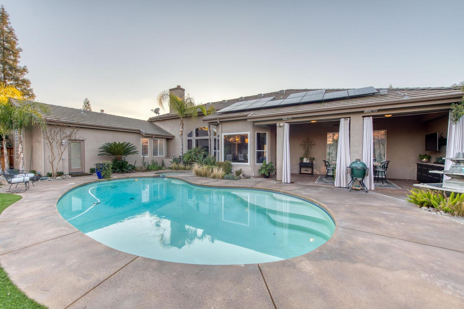 1081 North Harvard Avenue Clovis, CA 93611 - Photo 41 of 57 a view of a house with swimming pool and sitting area