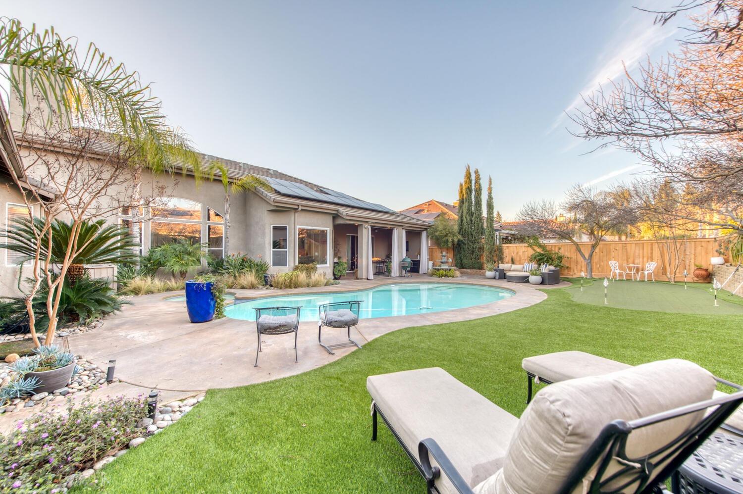 1081 North Harvard Avenue Clovis, CA 93611 - Photo 44 of 57 a view of a house with a yard patio and fire pit