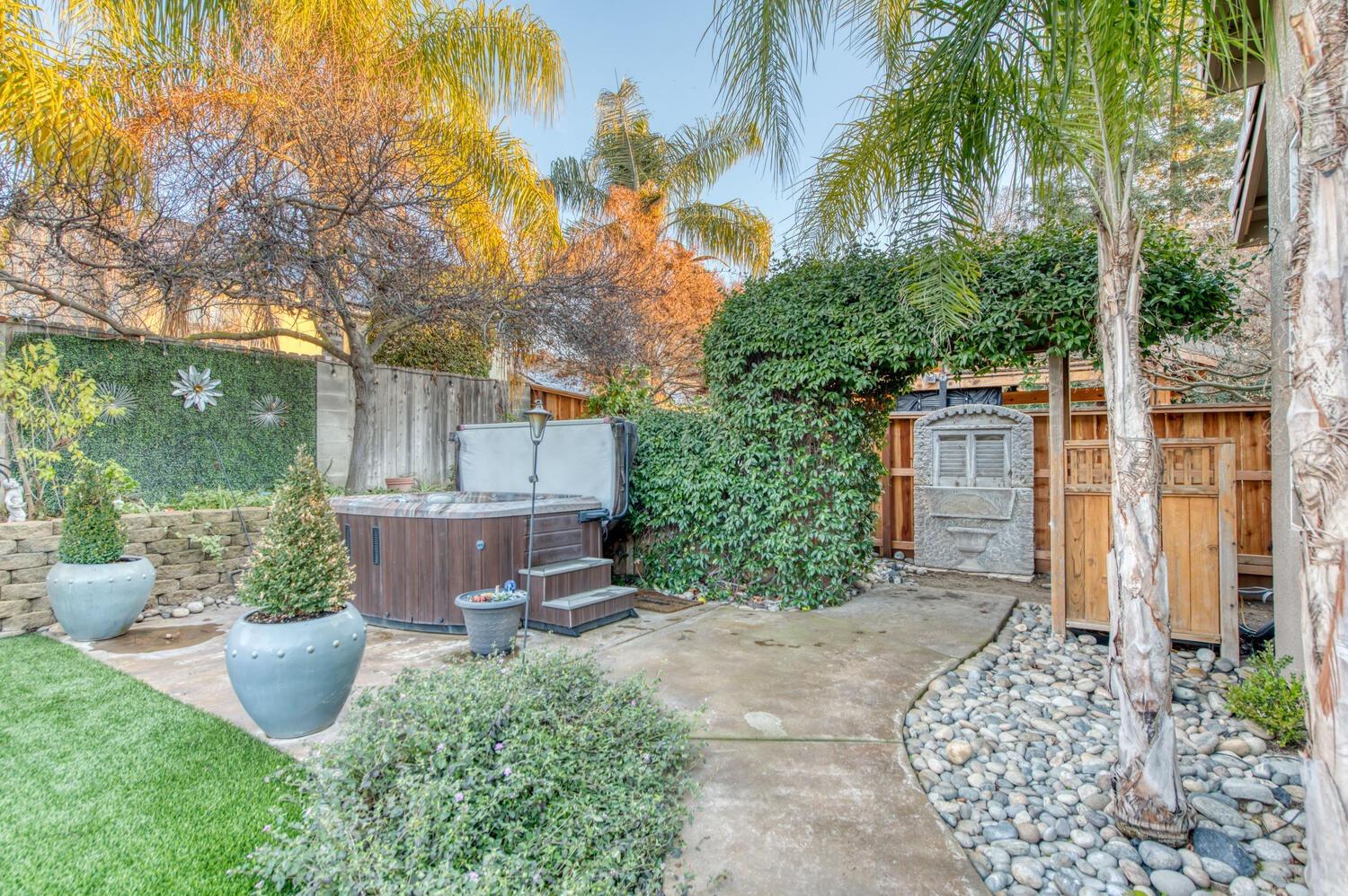 1081 North Harvard Avenue Clovis, CA 93611 - Photo 45 of 57 a view of a backyard with potted plants and large tree